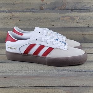 white adidas with red stripes